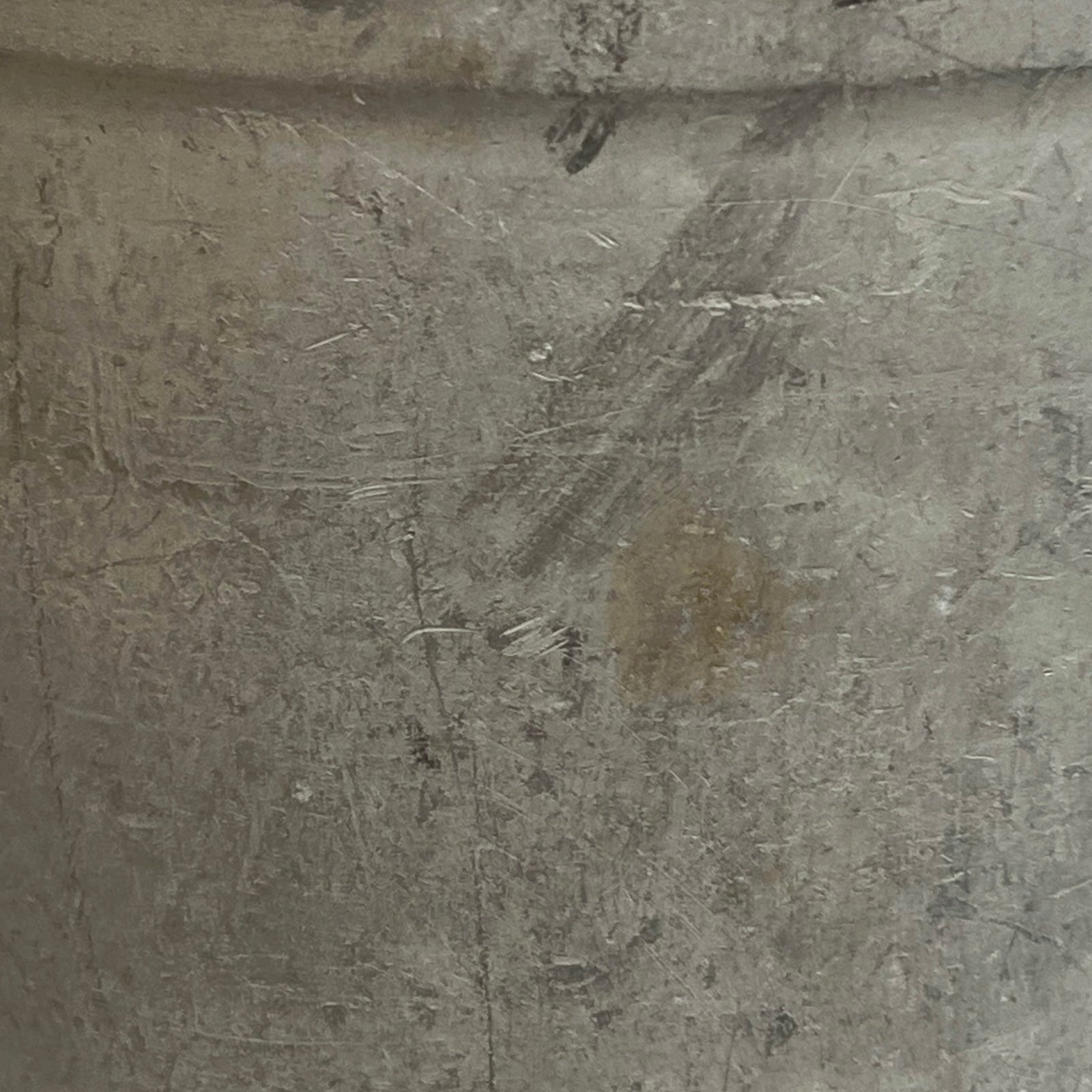 Close up of a vintage metal milk churn on a white background