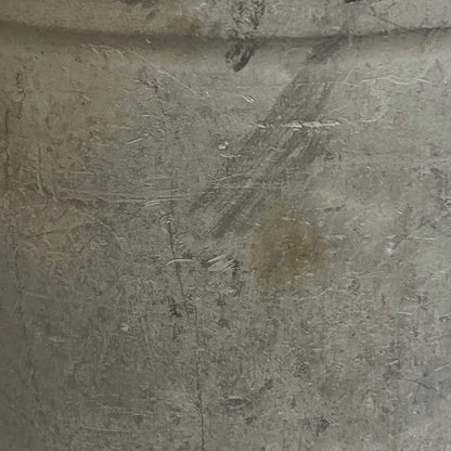 Close up of a vintage metal milk churn on a white background
