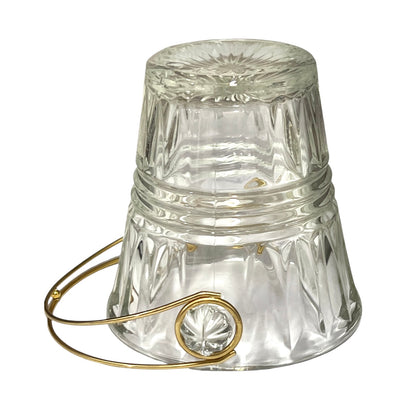 Clear glass ice bucket with gold handle on a white background