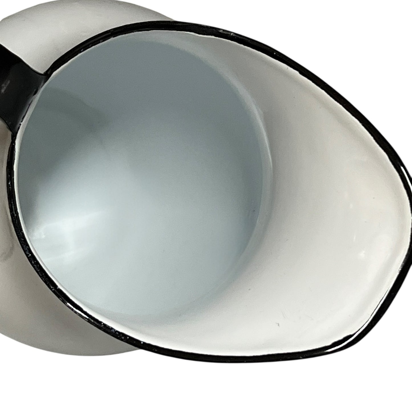 Close-up of a white jug with black rim on a white background