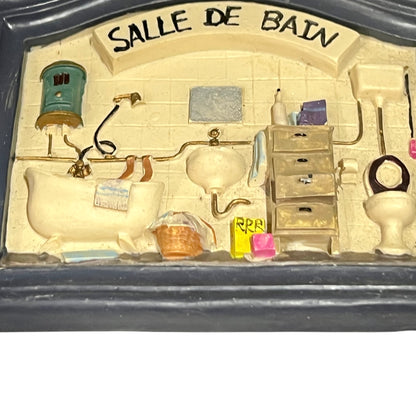 Close-up of a vintage bathroom door sign on a white background