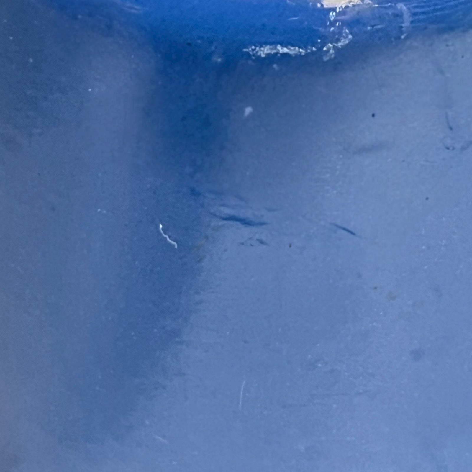 close up of  cast iron pan with beige interior on a white background
