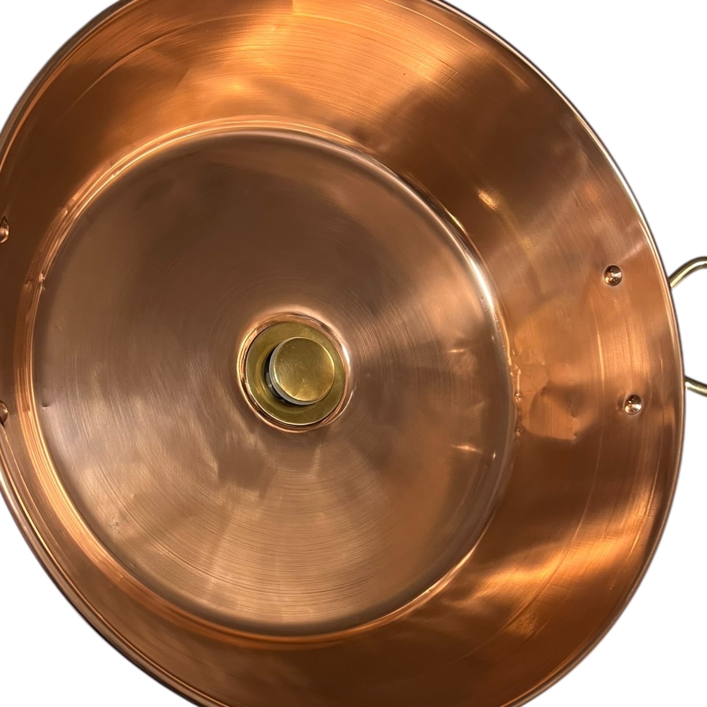 Close-up of a copper up cycled sink with brass handles on a white background.