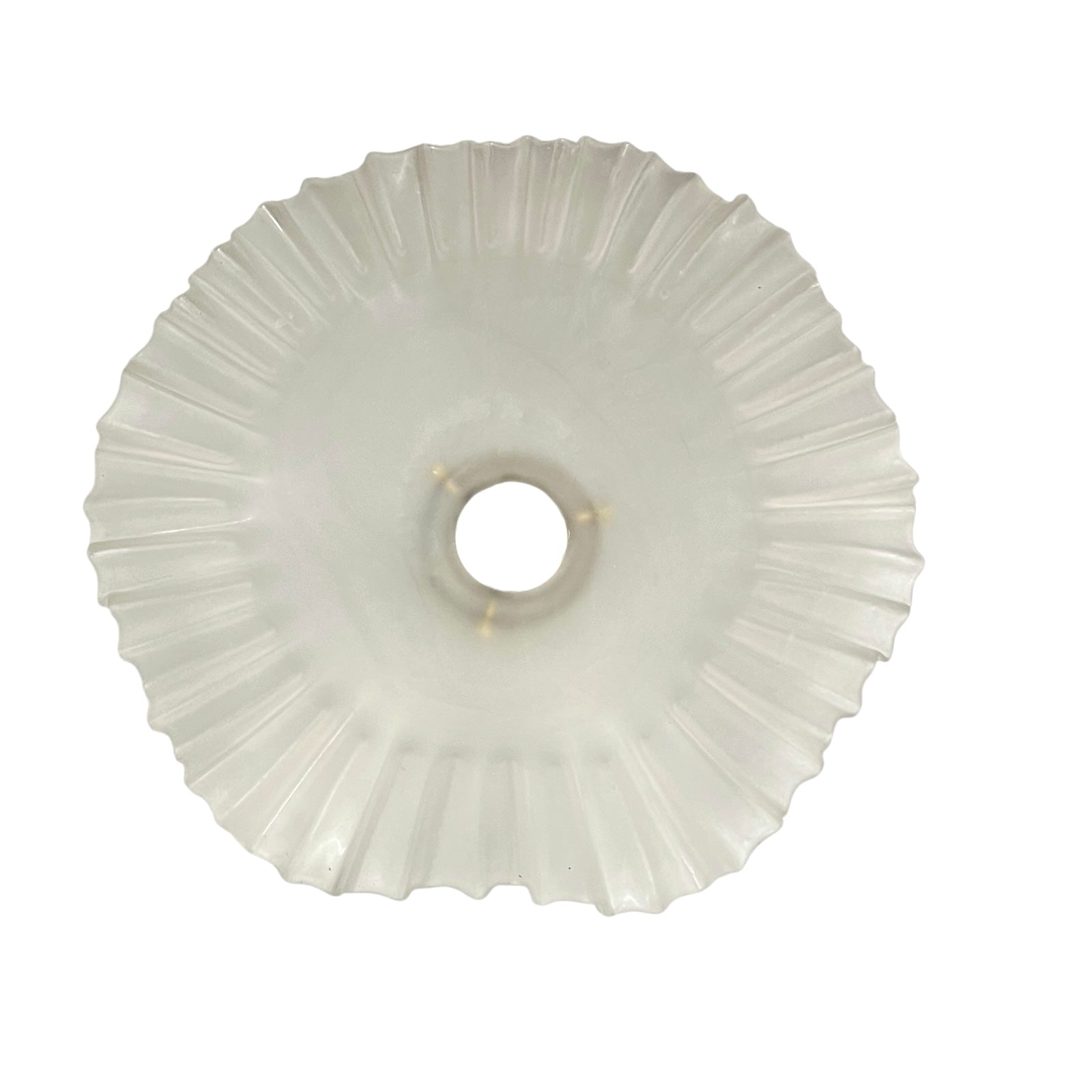 Close-up of a glass lamp shade with a scalloped edge on a white background