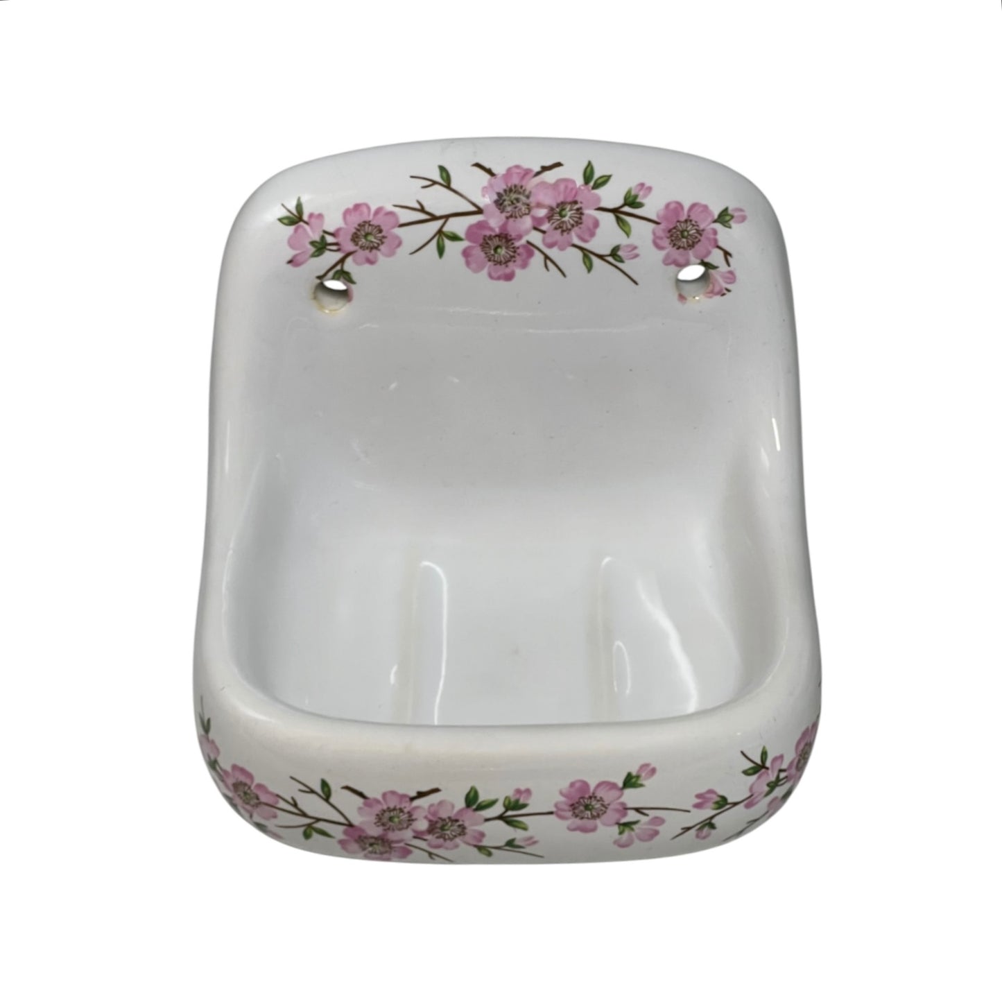 A white ceramic wall-mounted soap dish with a pink floral pattern around the rim, shown against a plain white background.