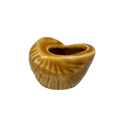small brown ceramic escargots snail pot on a white background