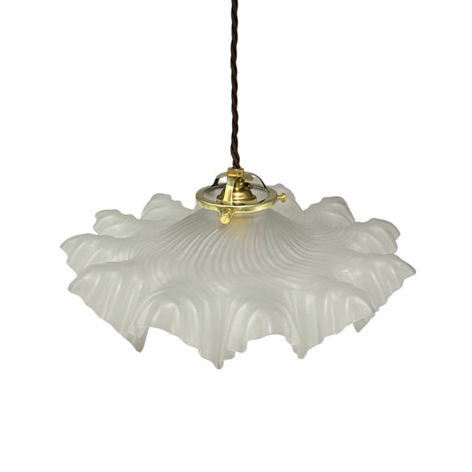 A French vintage Art Deco-style lampshade made of clear frosted glass with a frilled edge, suspended by twisted-style wiring and brass fittings, perfect for adding charm to a period room or retro home, displayed against a white background.