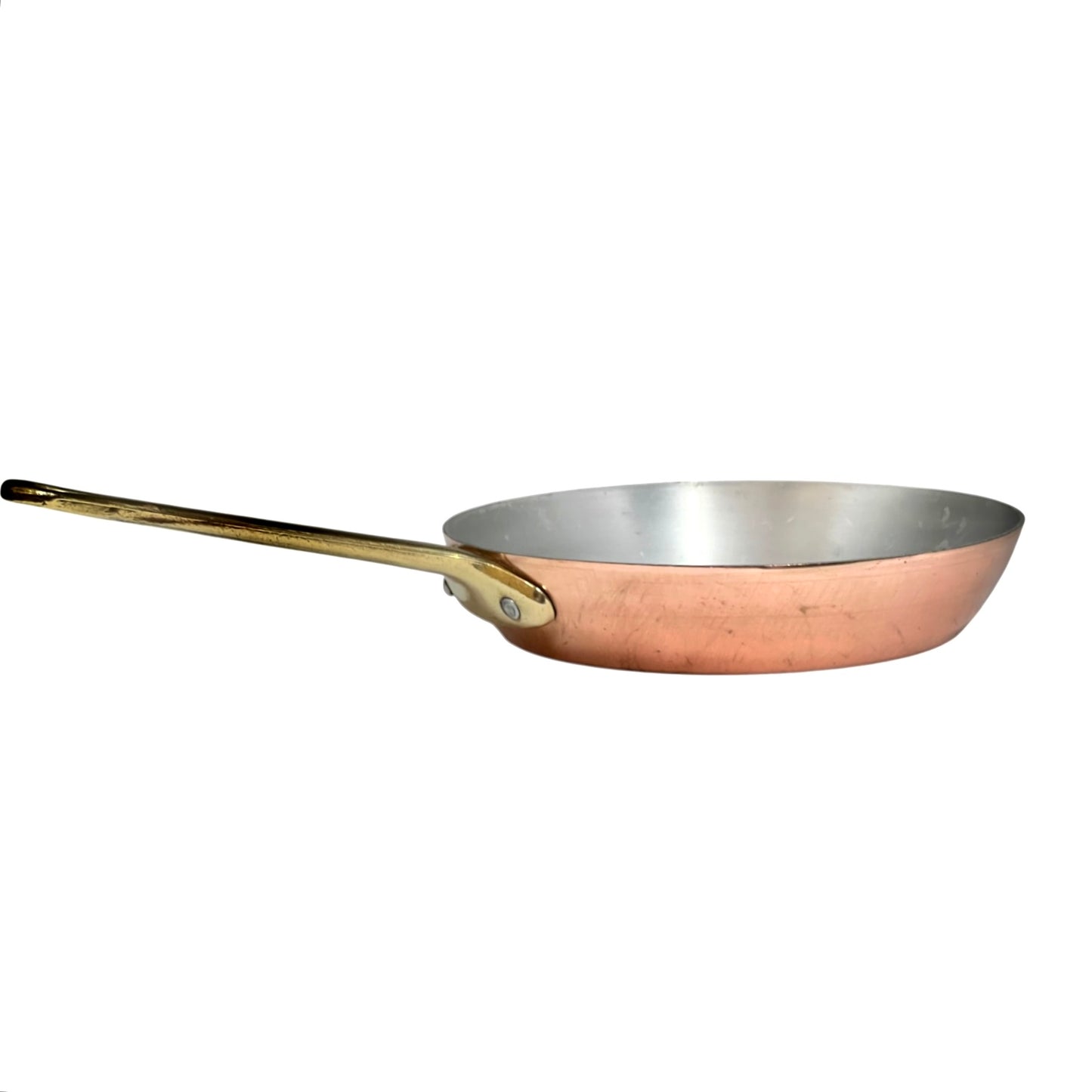 A copper saute pan with a polished steel interior and a long brass handle, shown from a side profile on a white background.