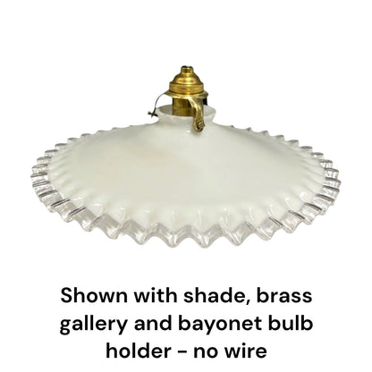 An off-white glass shade with a fluted, scalloped edge, shown with a brass gallery and bayonet bulb holder against a white background, with text below stating 'Shown with shade, brass gallery and bayonet bulb holder - no wire'.