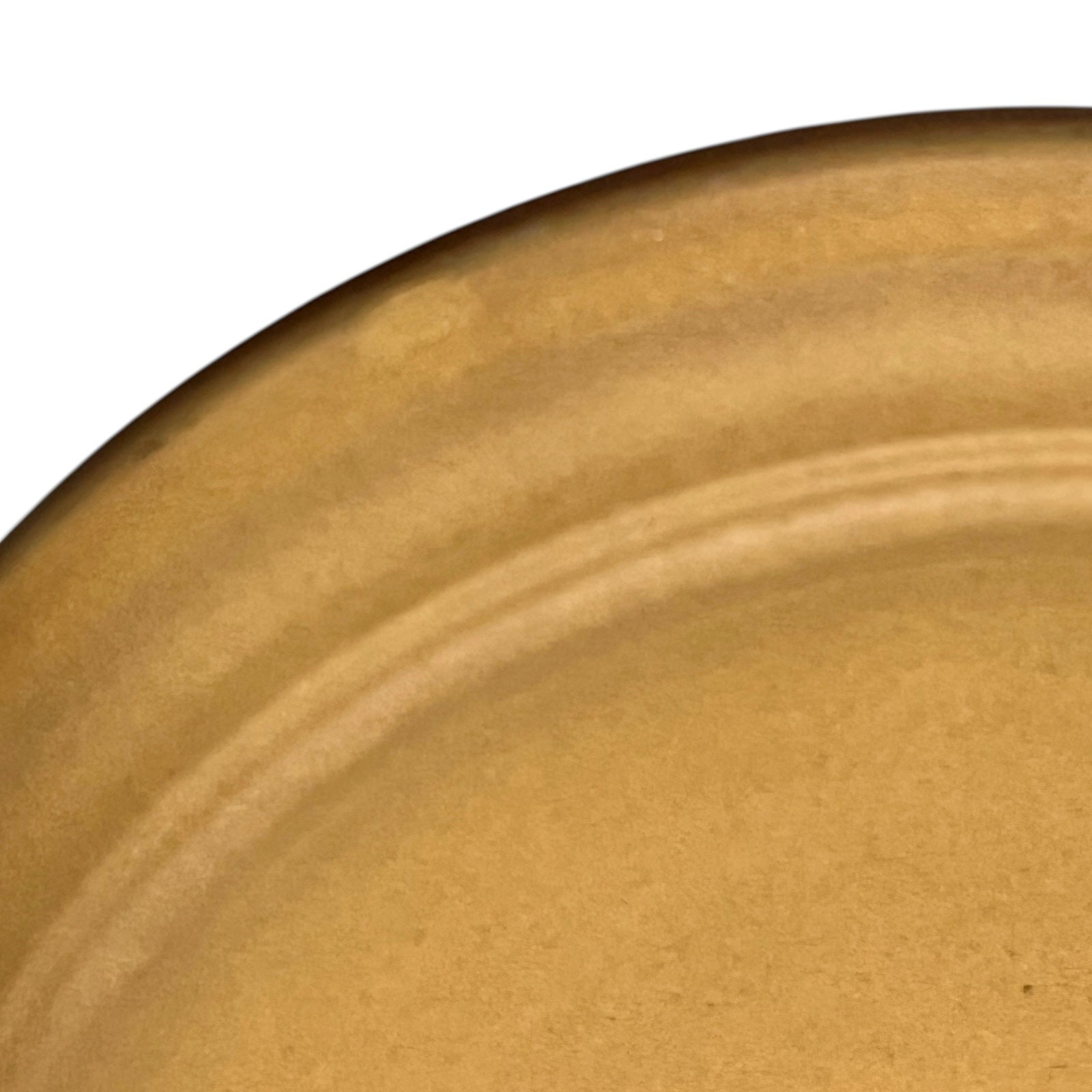 Close-up of a brown ceramic plate with a textured surface