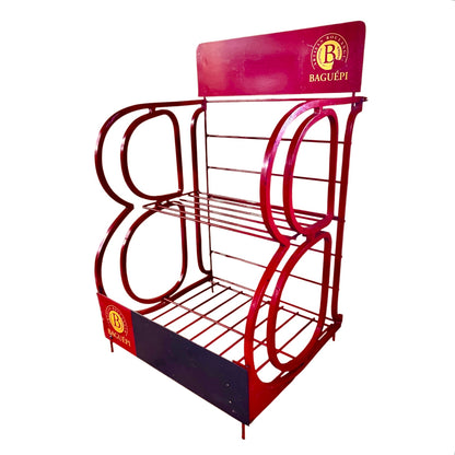 A red metal retail display rack with three tiers, featuring a decorative arch design and 'BAGUÉPI' branding on the top panel and base.