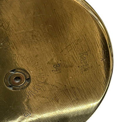 Close up of a brass WW1 German shell case on a white background