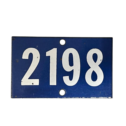 A rectangular blue metal house number plaque with the white numbers '2198' and two mounting holes, shown against a plain white background.