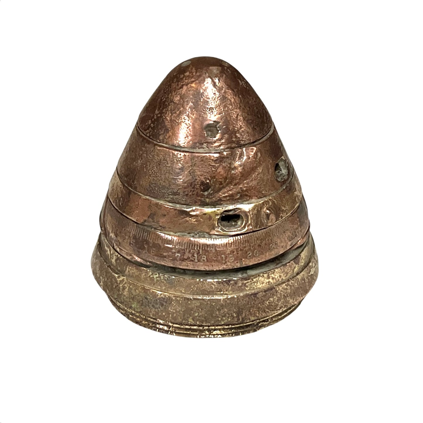 WW1 brass fuse now repurposed as a paperweight, with markings for identification of wear, on a white background