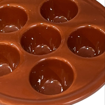 Brown ceramic egg ,snail, or escargots plates with multiple compartments on a white background