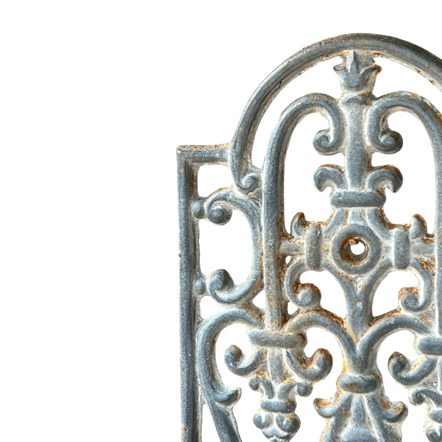 close up of a metal decorative wall planter on a white background