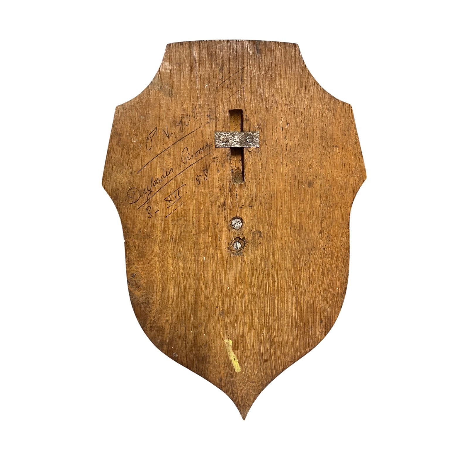 Wooden shield-shaped object with text and metal hook hole on a white background