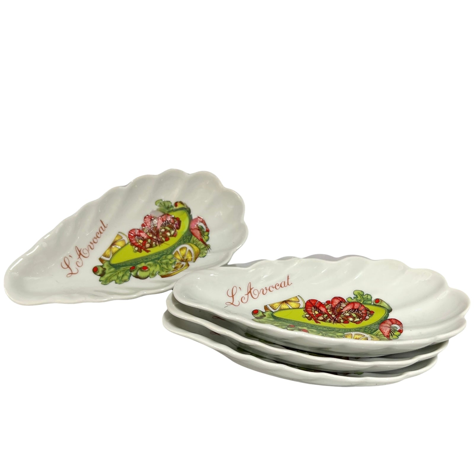 Set of shell-shaped porcelain avocado dishes  decorative designs and 'L'Avocat' branding on a white background.