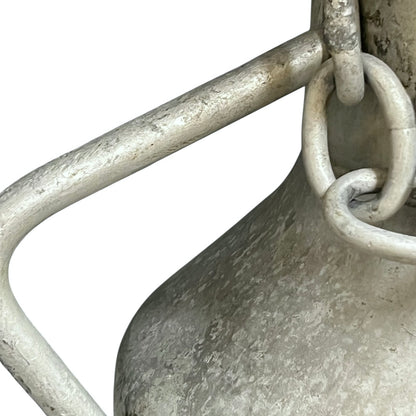 Close up of a vintage metal milk churn on a white background