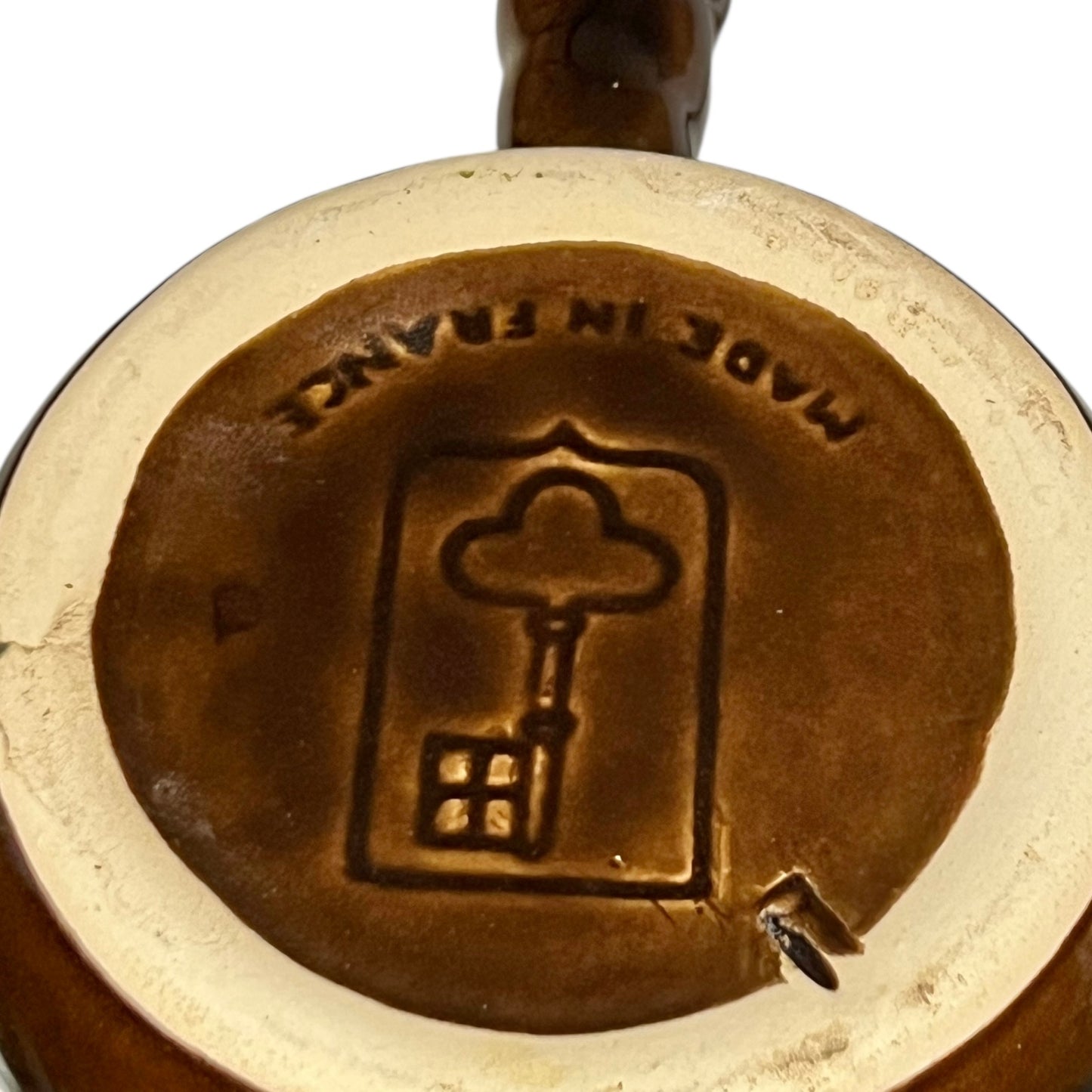 Close up of snail plates with handles and the Emile Henry makers stamp on a white background