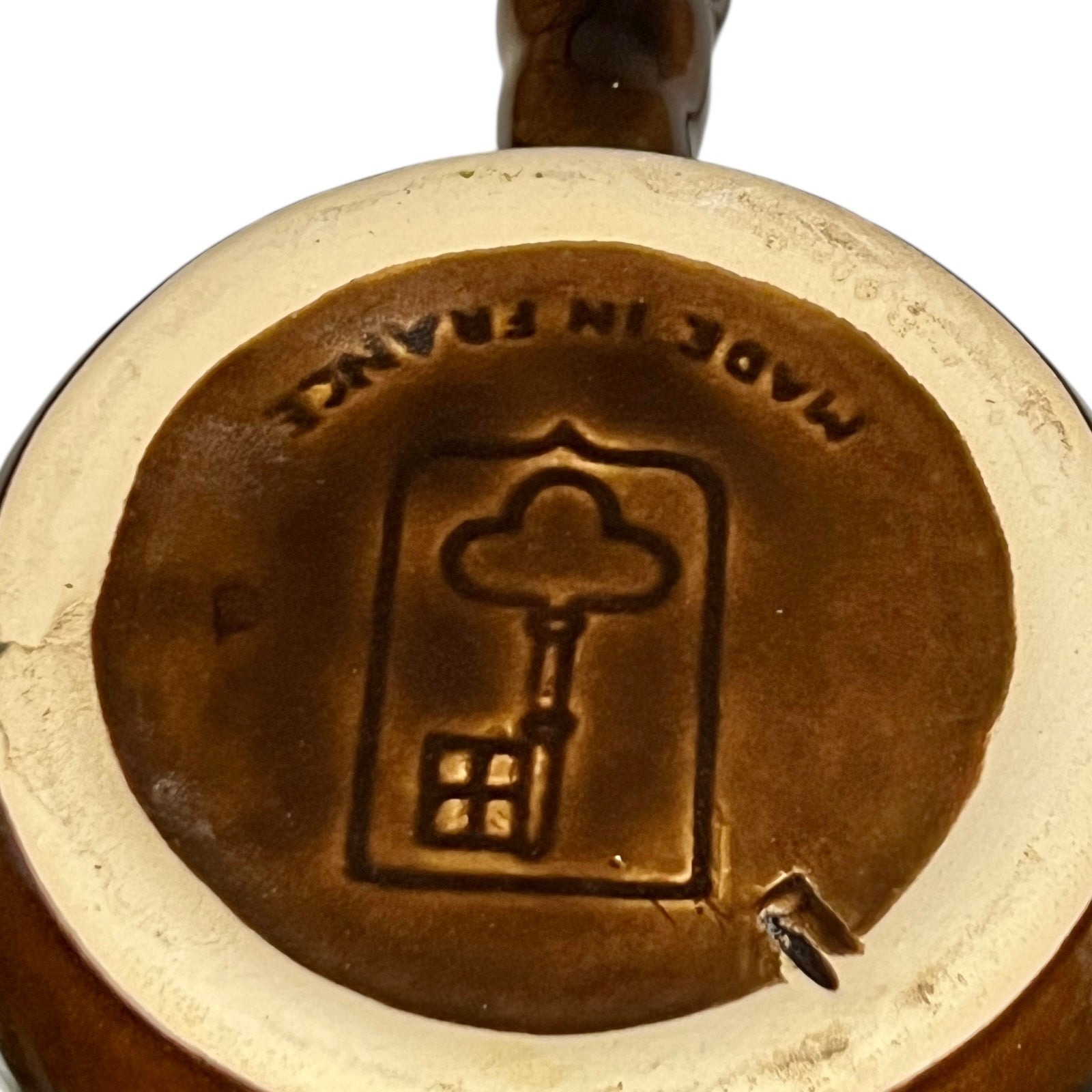 Close up of snail plates with handles and the Emile Henry makers stamp on a white background