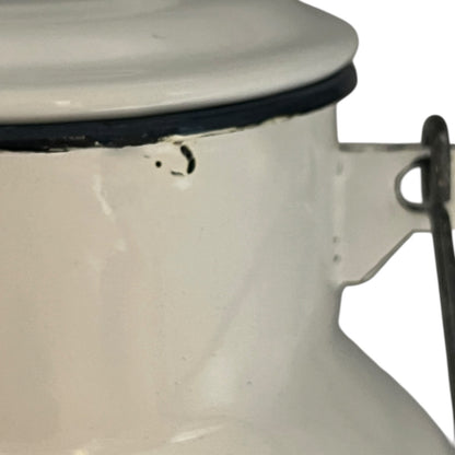 Close up of a white enamel milk churn and mug with duck design on a white background