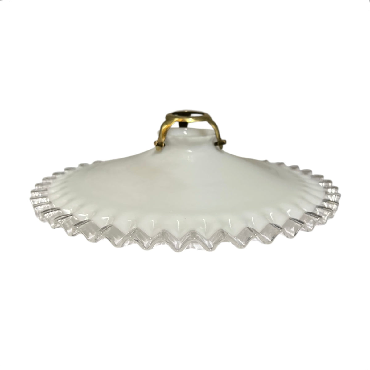 A vintage white milk glass lamp shade with a scalloped, fluted edge and a small gold metal handle, shown against a plain white background.