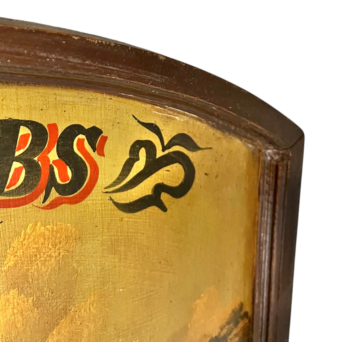 Close-up detail of a vintage wooden picture showing a gold-painted centre with black and red painted lettering and a dark brown wooden frame.