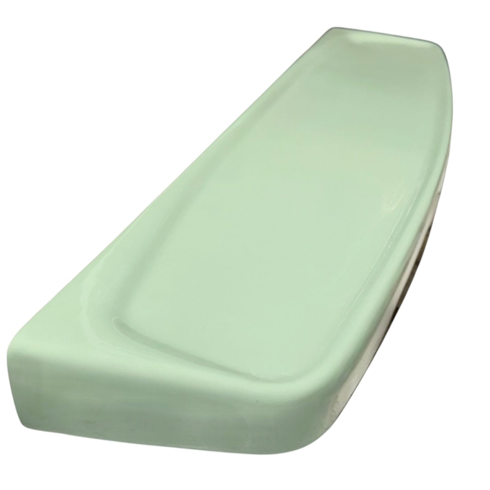 Pale green ceramic shelf on a white background