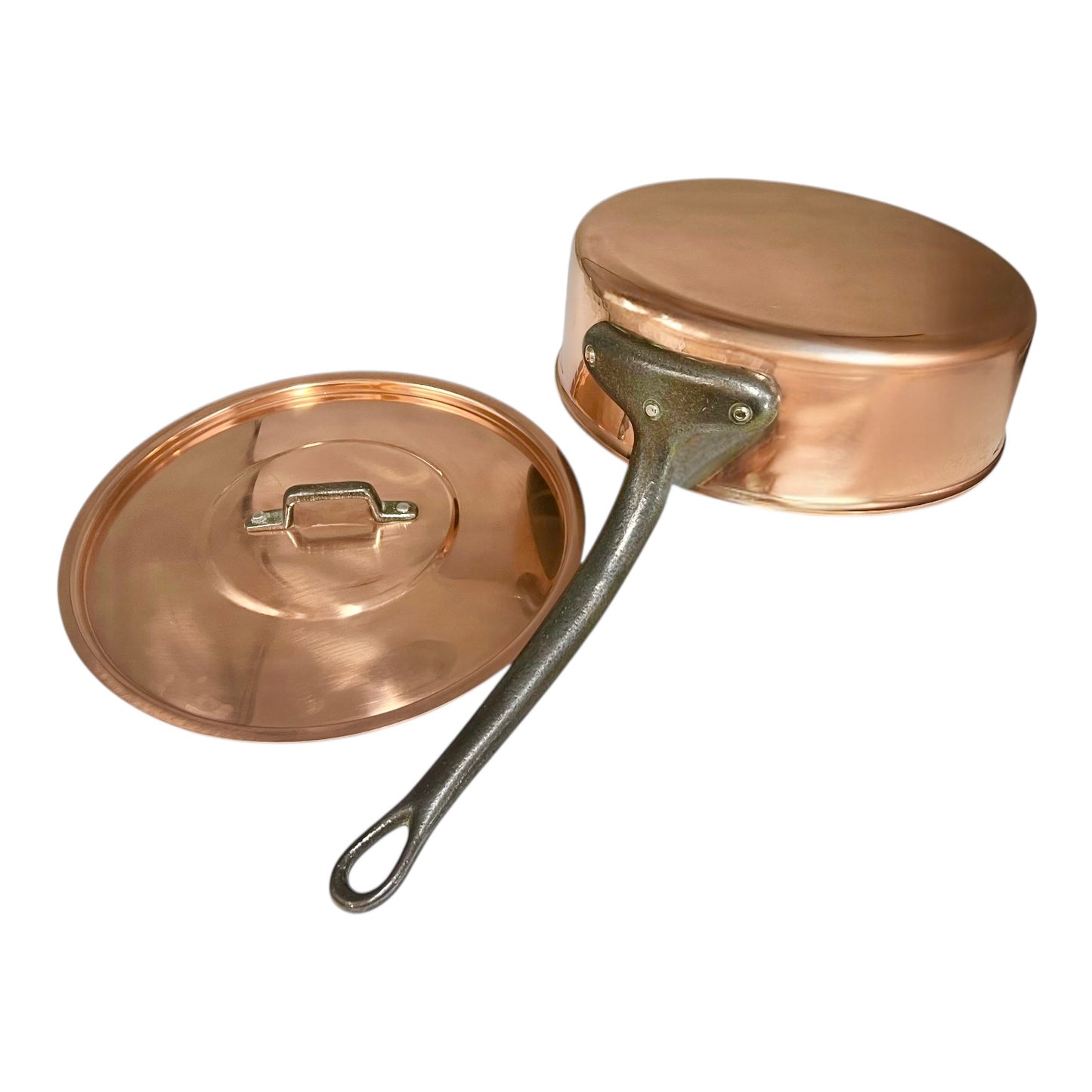 Copper pot with a lid and cast iron handle on a white background