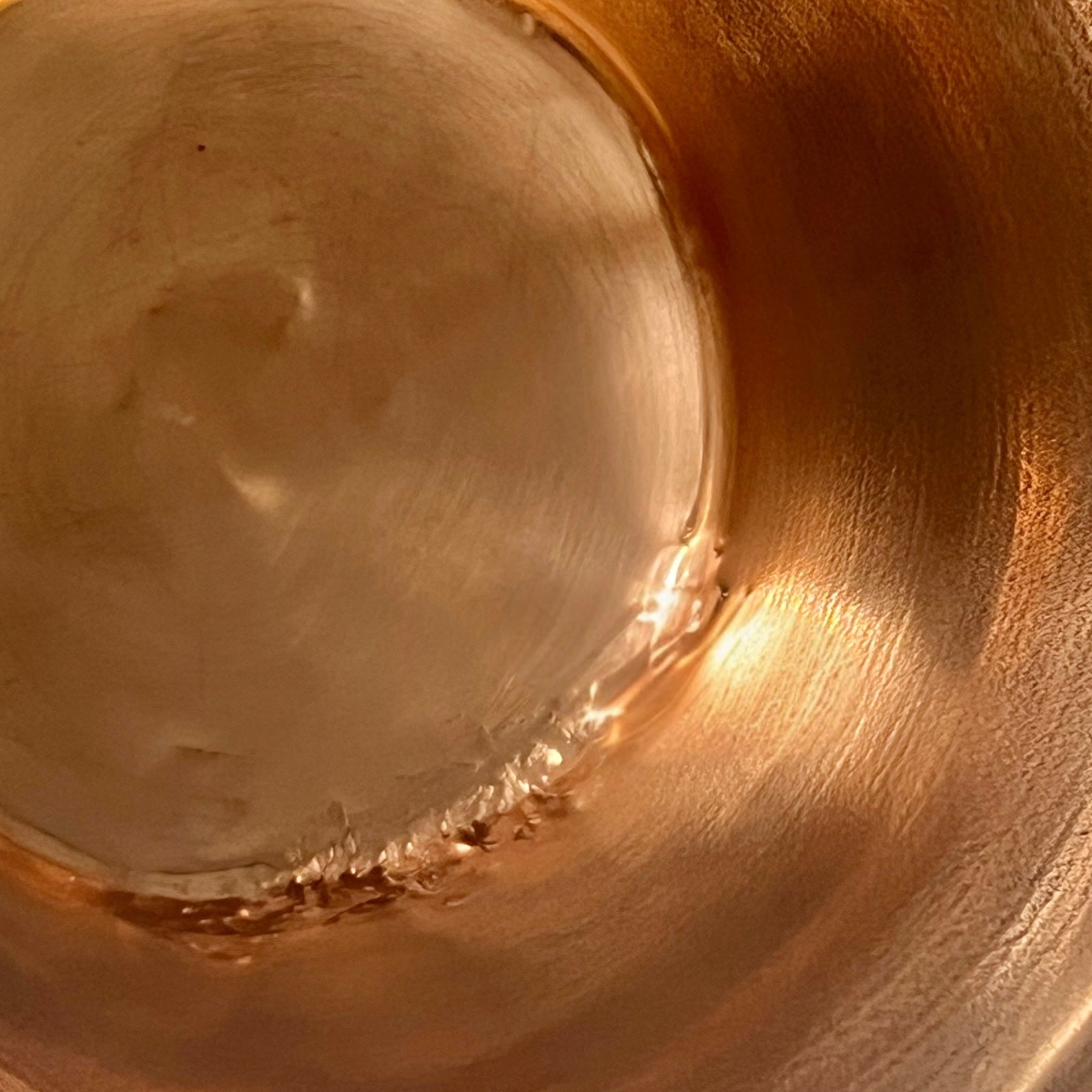 Close up of French vintage copper ladle pan with a black handle on a white background