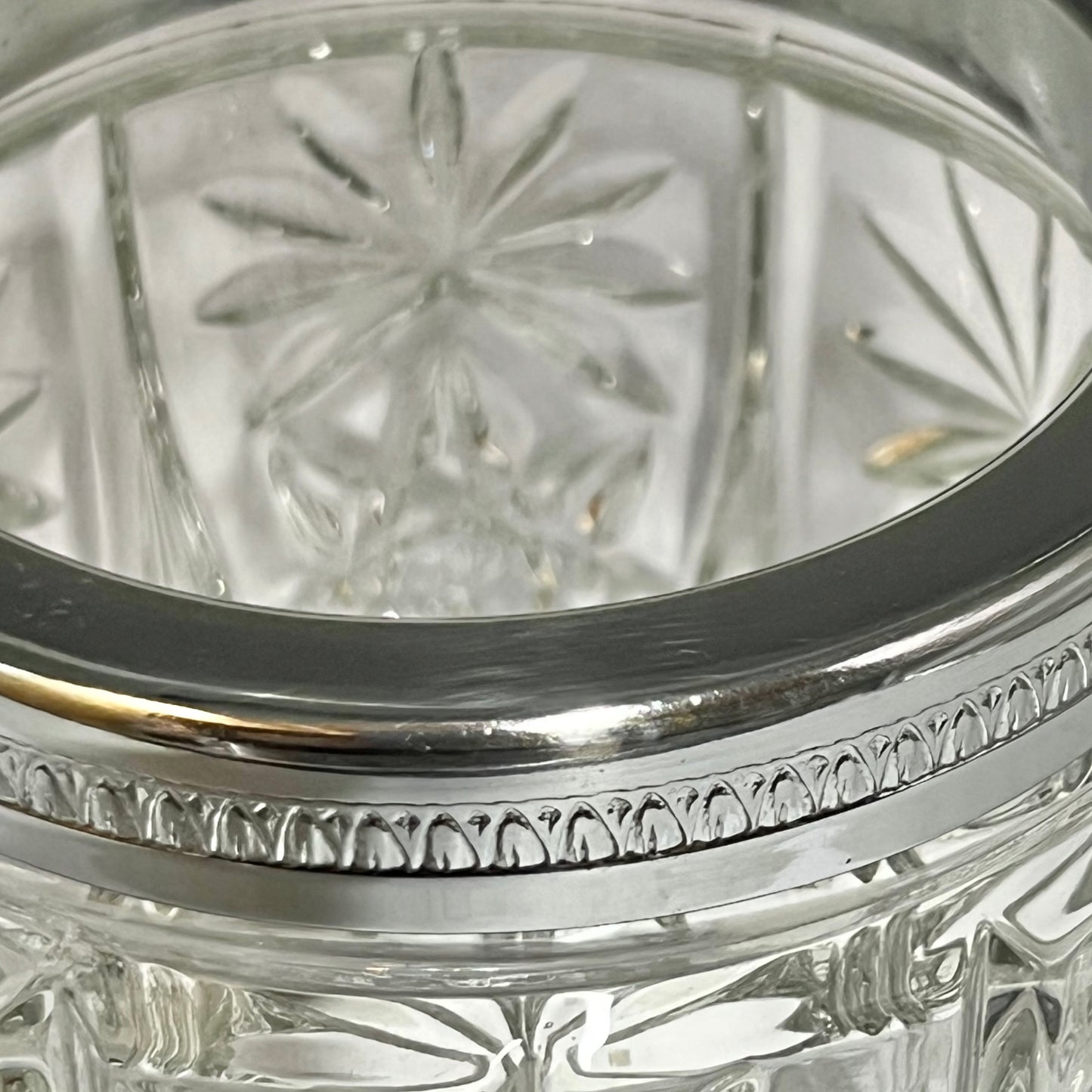 Close up of a decorative glass vintage ice bucket on a white background