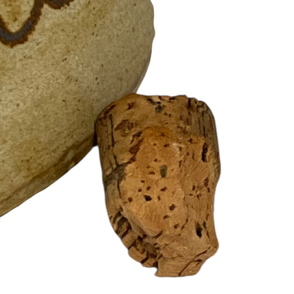 Close-up of a cork stopper on a white background