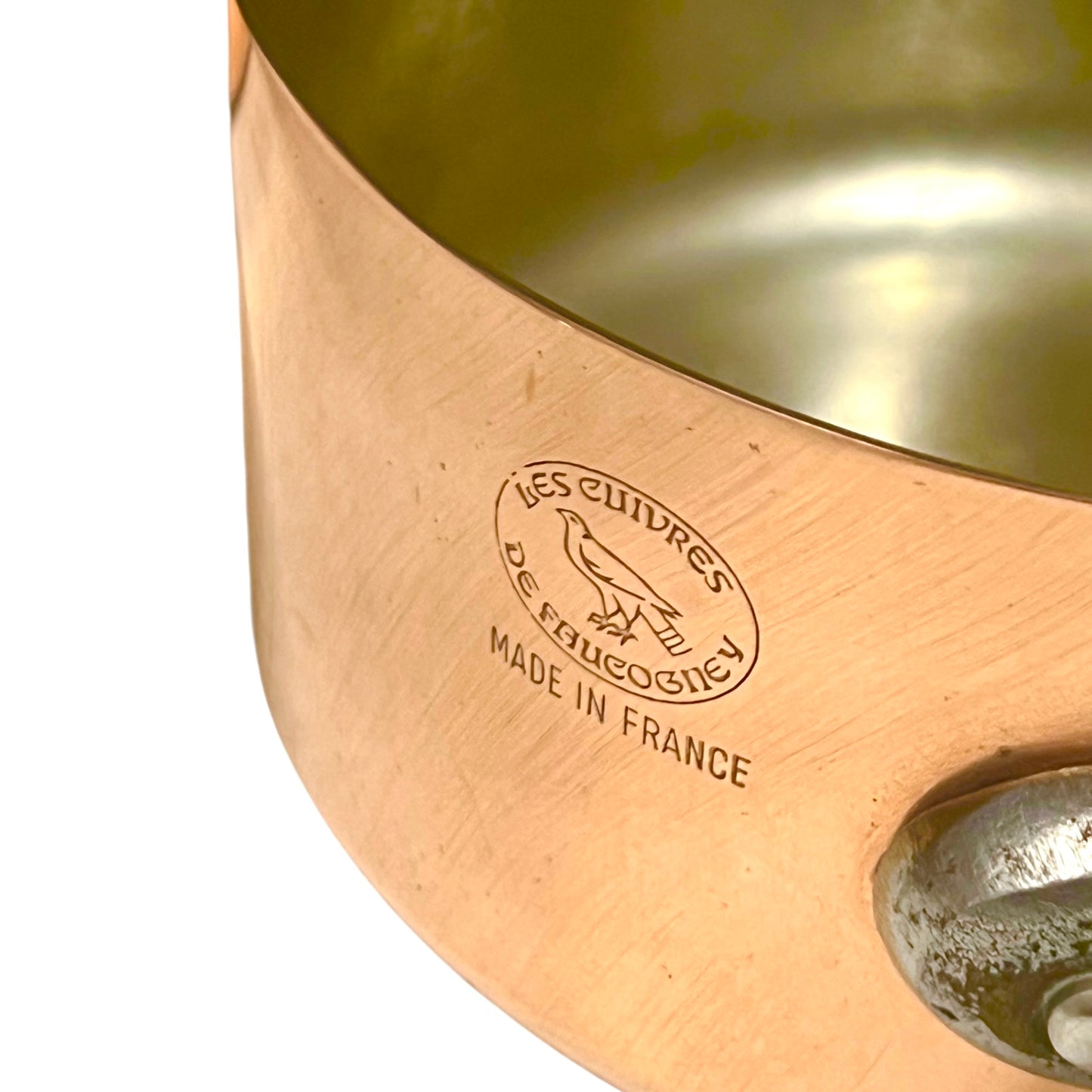 Close-up of copper cookware with iron handles on a white background