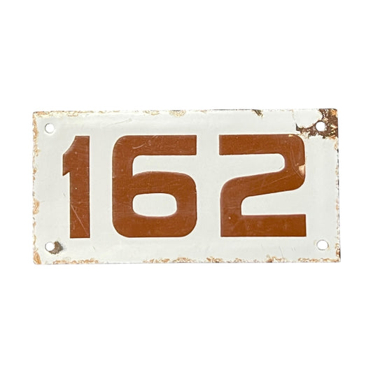 Vintage-style metal sign with the number '162' on a white background