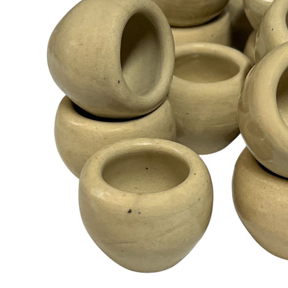 Set of beige ceramic escargots snail cups on a white background