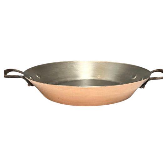 Copper frying pan or gratin pan with new tin lining and cast iron handles on a white background for sale from All Things French Store