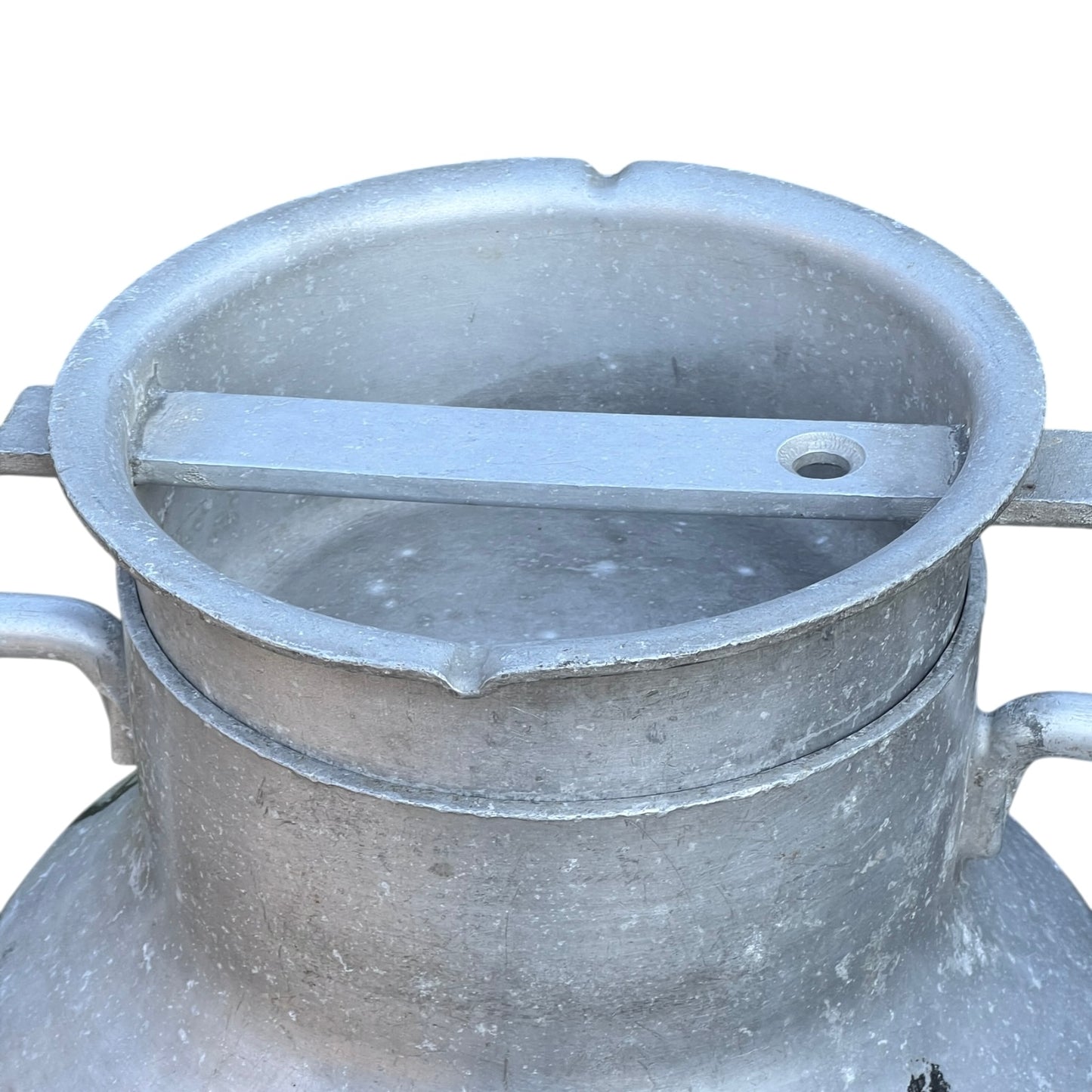 Close up of a Vintage French aluminium milk churn with a lid on a white background