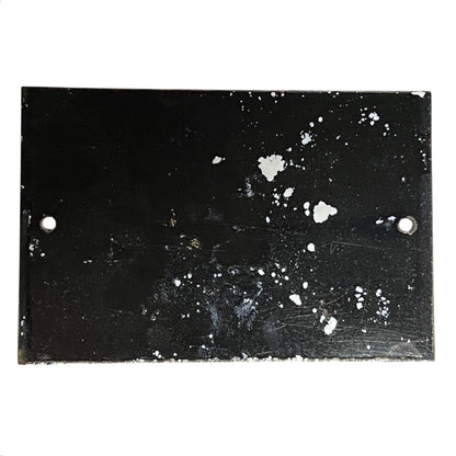 Black surface with white speckles and scratches on a white background