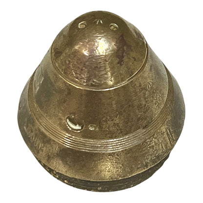 WW1 brass fuse paperweight on a white background