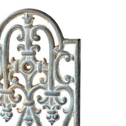 close up of a metal decorative wall planter on a white background
