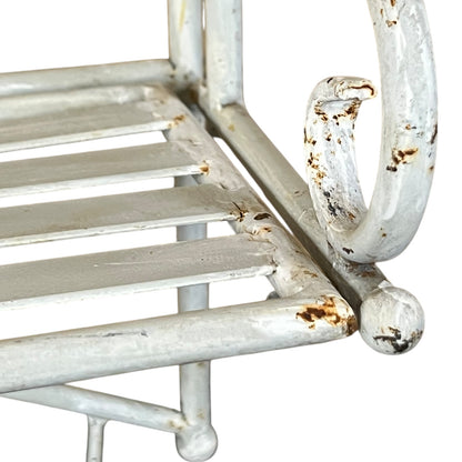 Rustic metal shelf with white paint and visible rust on a white background
