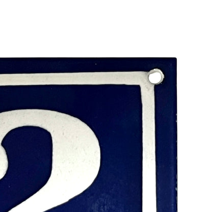 Close-up of a blue and white sign with the number '2'