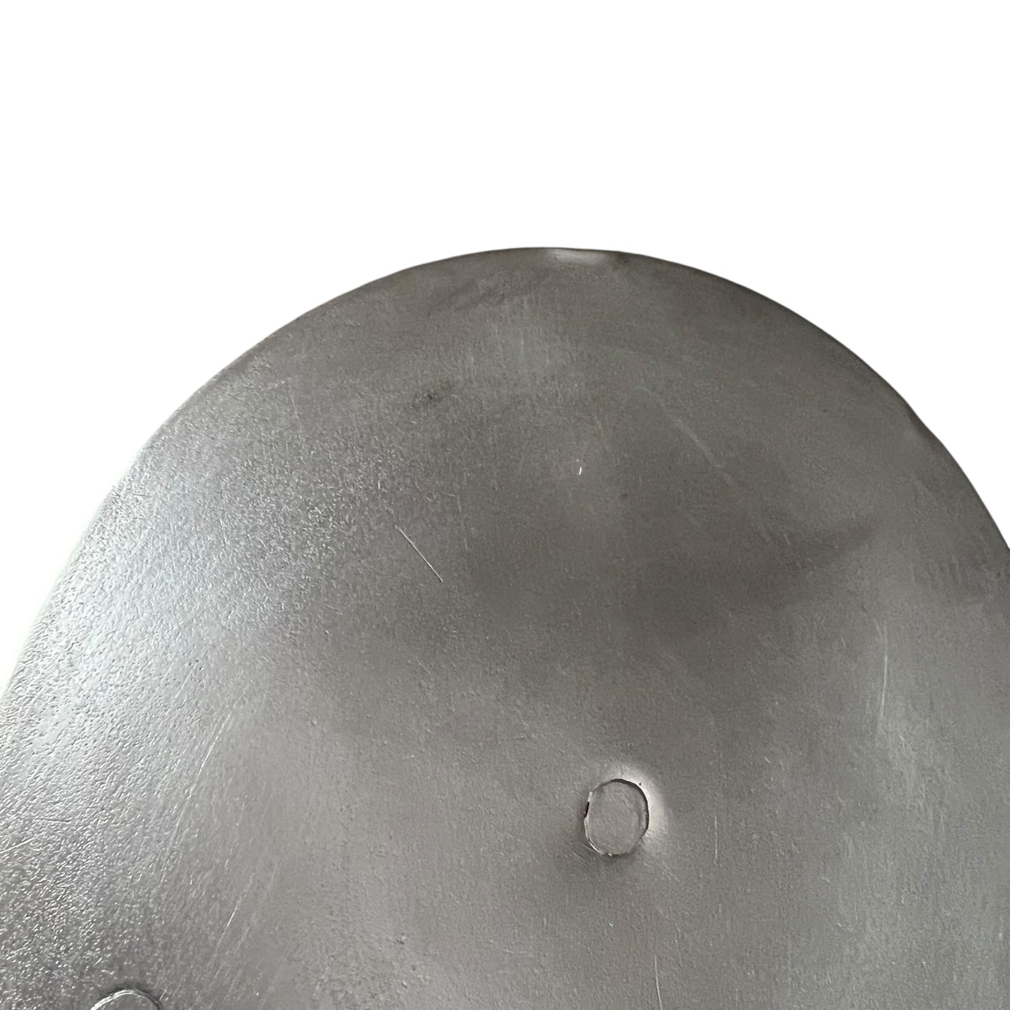 Close up French copper pan lid showing hand wiped traditional new tin lining  on a white background