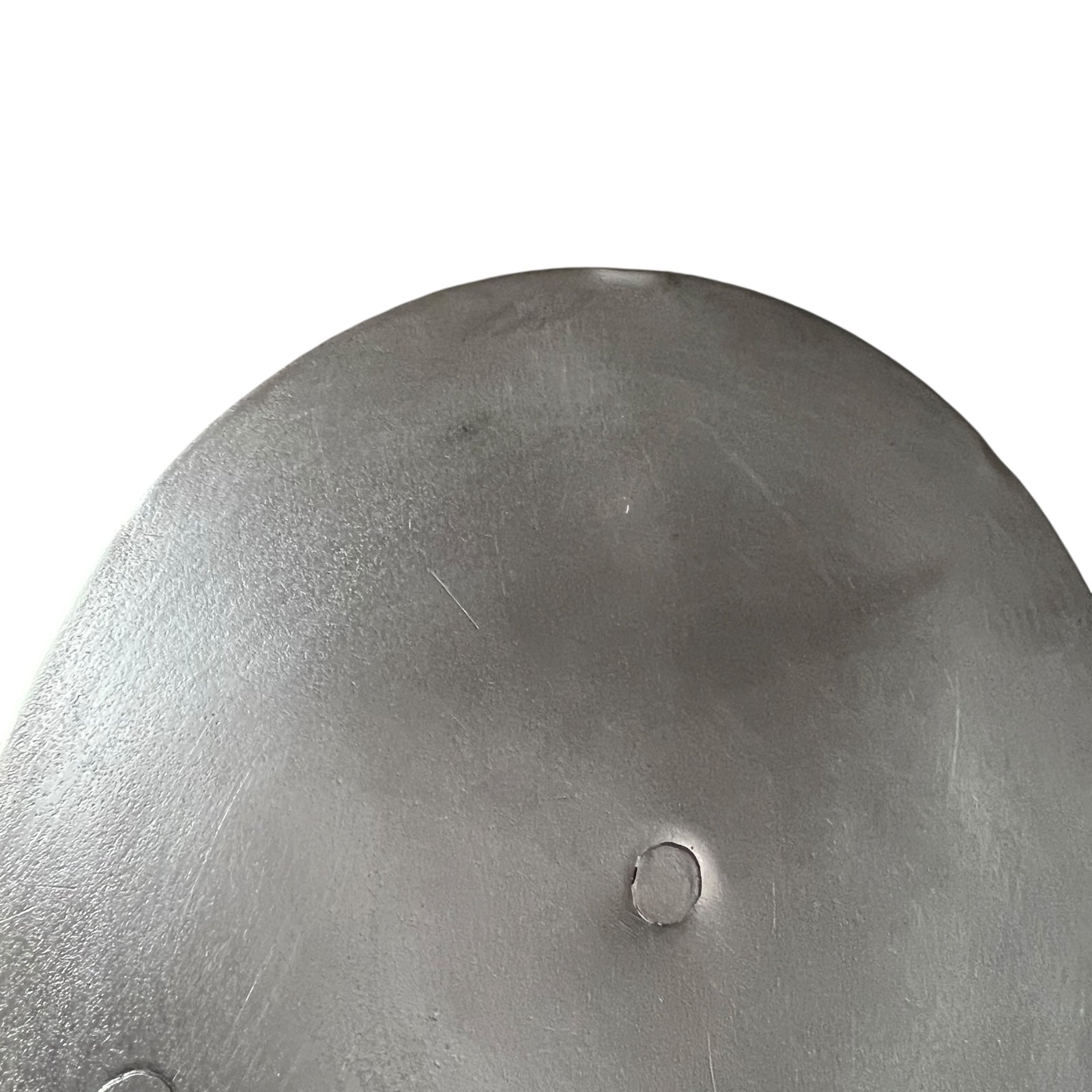 Close up French copper pan lid showing hand wiped traditional new tin lining  on a white background