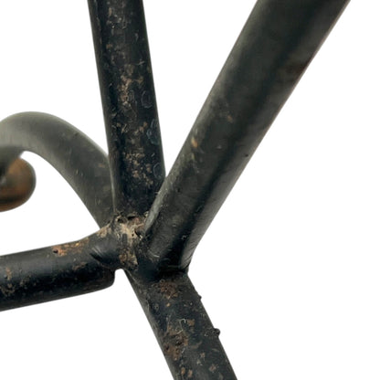 Close-up of a black metal stand on a white background