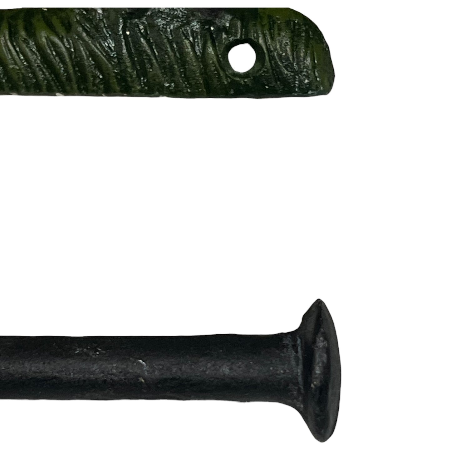 Two black metal objects with textured surface and central hole on a white background