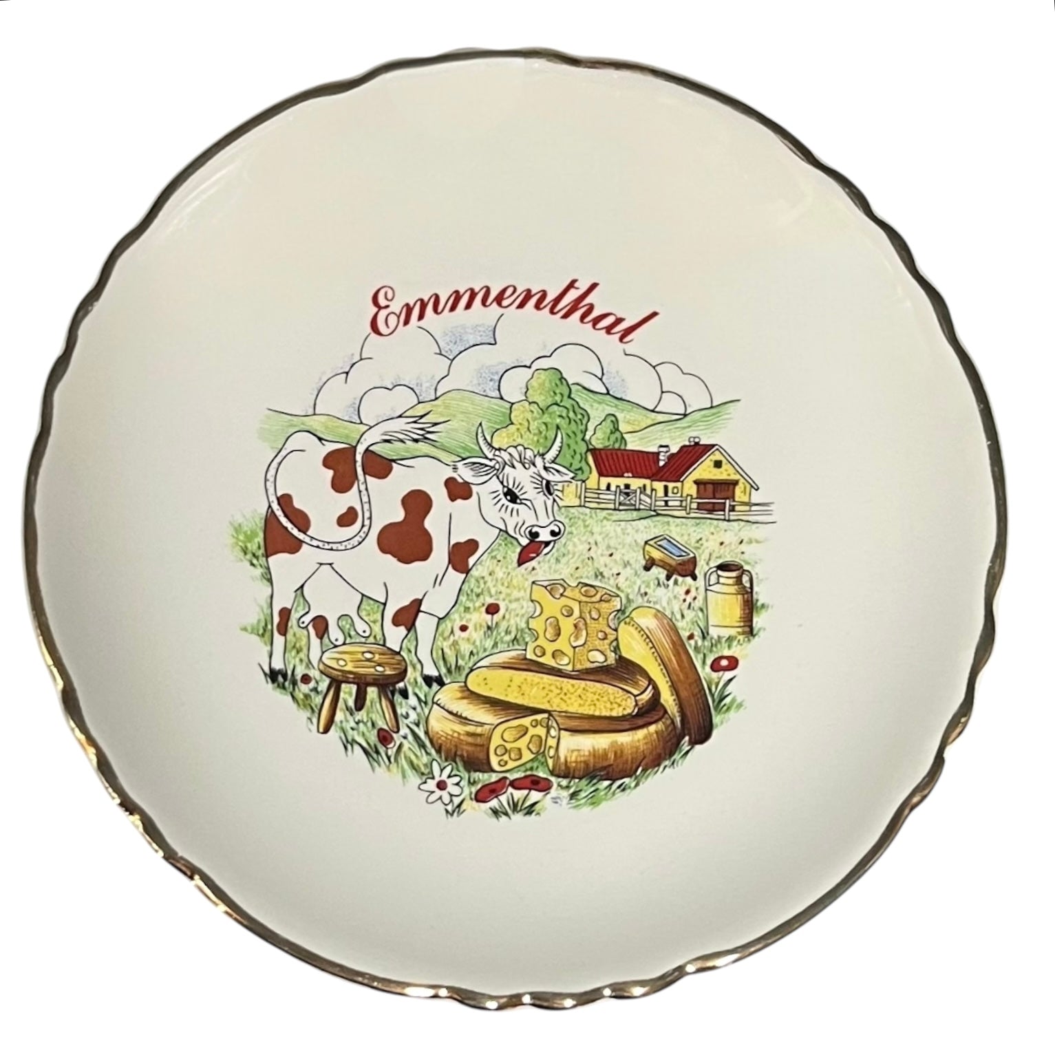 Decorative plate with a cow, cheese, and landscape illustration on a white background