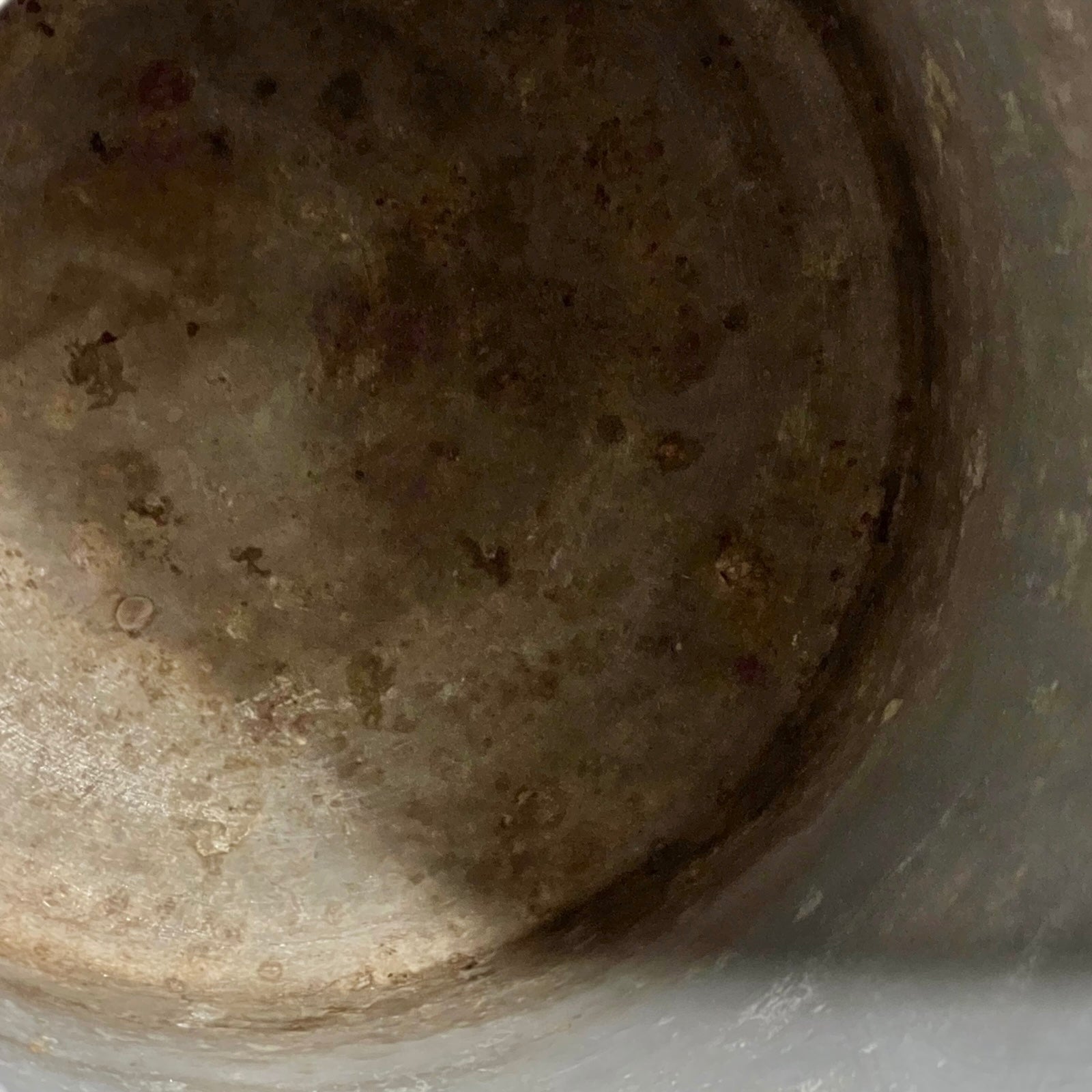 Close-up of interior of metal milk churn
