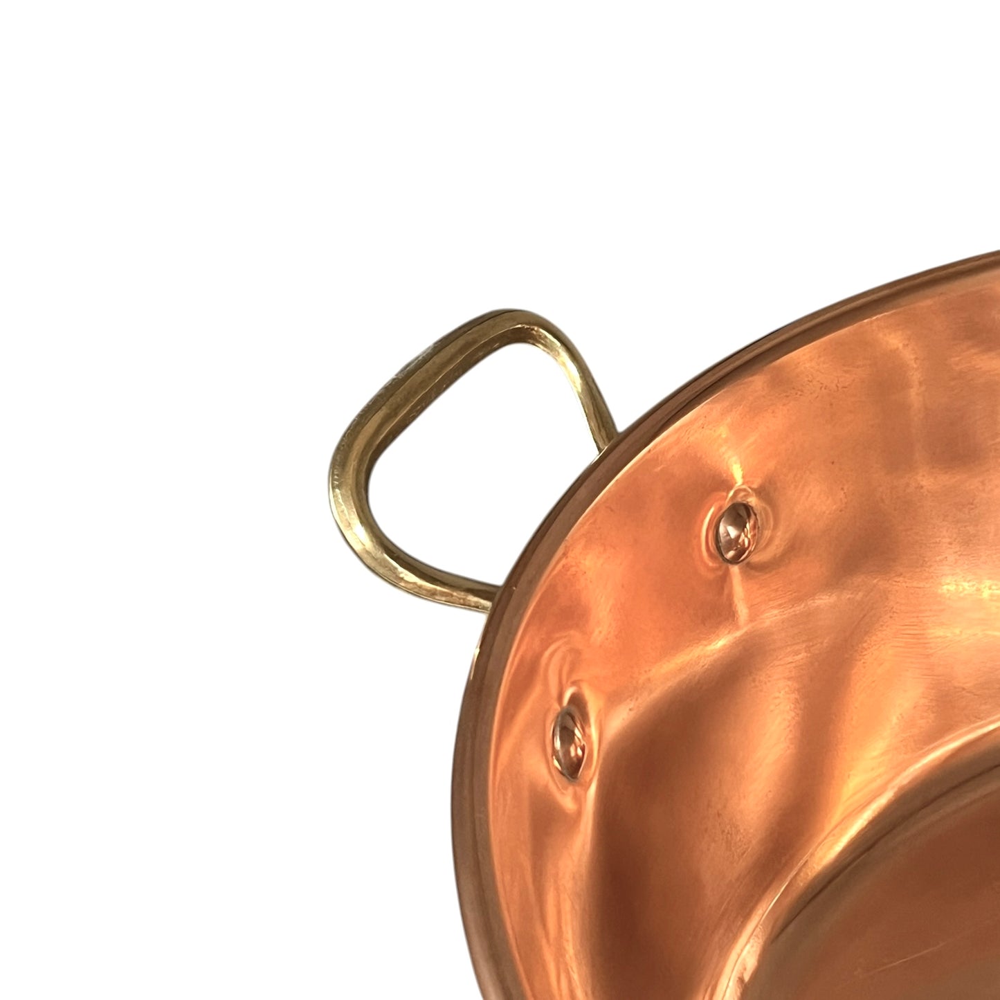 Close-up of a copper sink with a drain plug on a white background